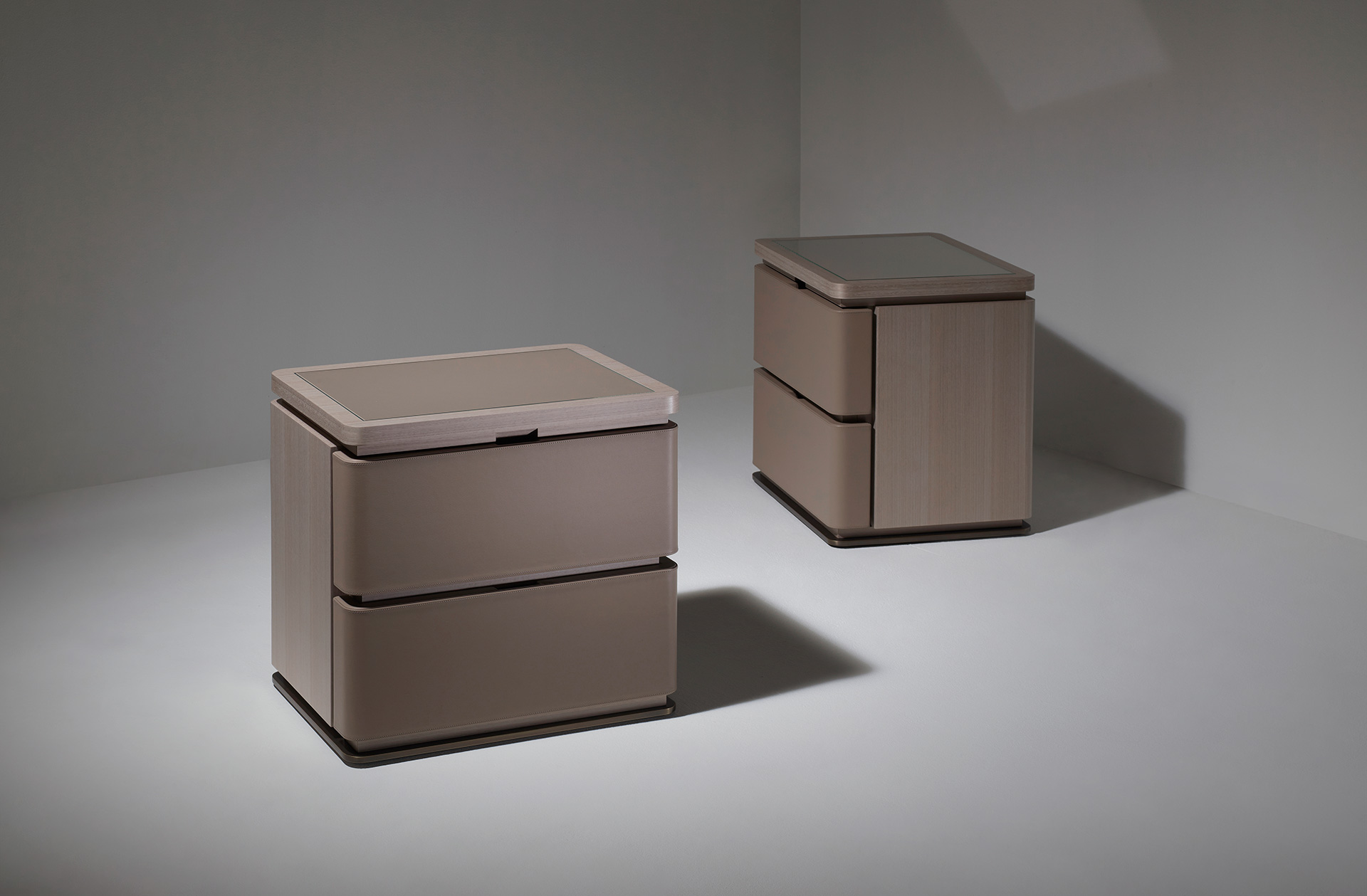 Au Bout de la Nuit is a wooden bedside table with drawers, bronze base and top covered in leather with glass, from Promemoria's Amaranthine Tales collection | Promemoria