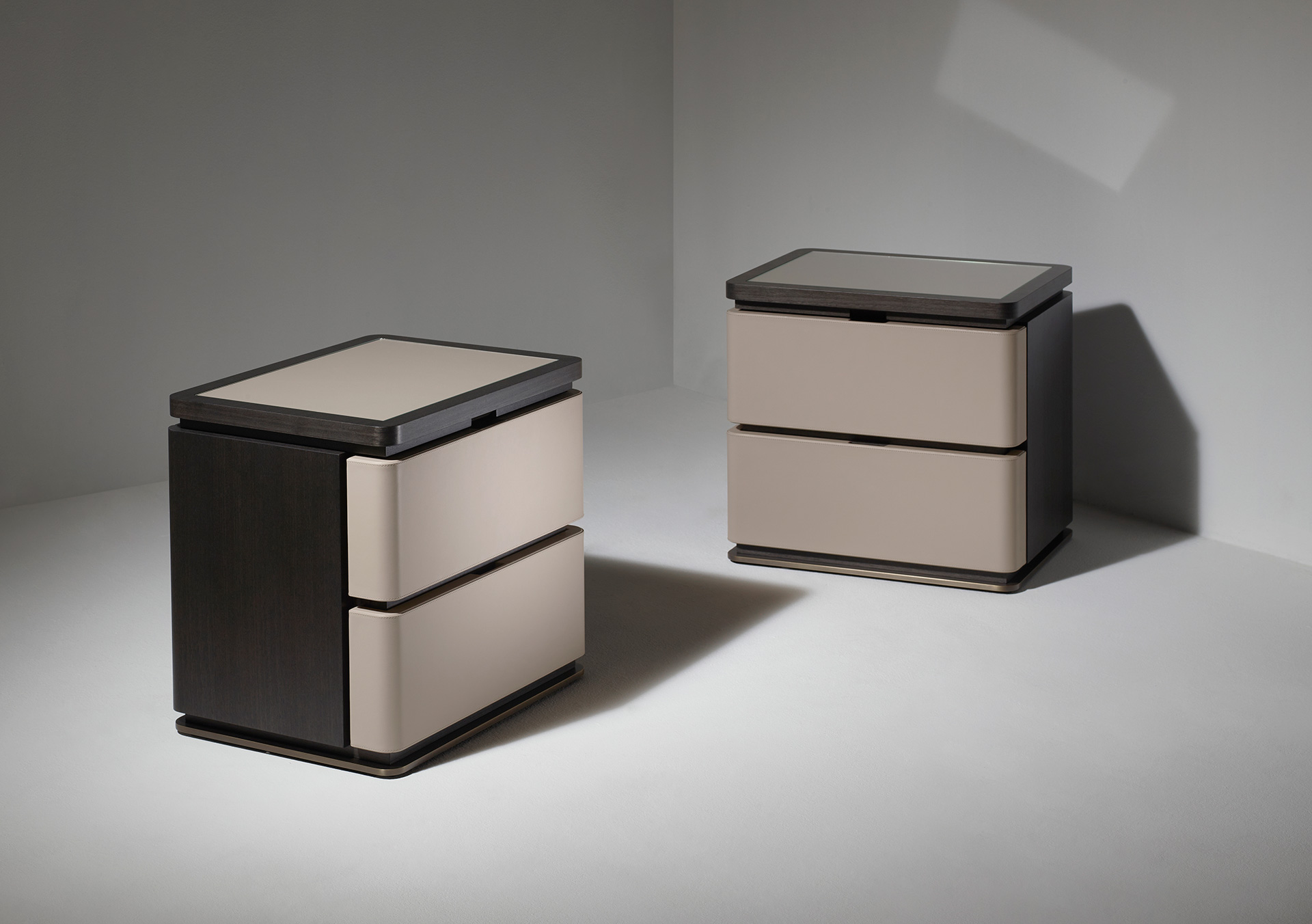 Au Bout de la Nuit is a wooden bedside table with drawers, bronze base and top covered in leather with glass, from Promemoria's Amaranthine Tales collection | Promemoria