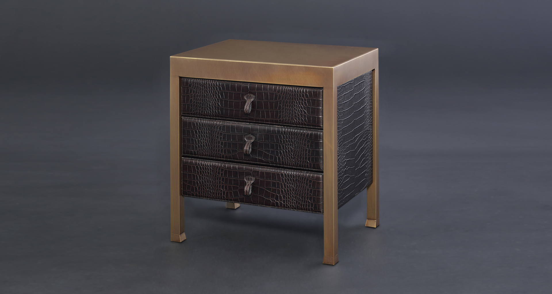 Gong is a bronze bedside table that can be covered in fabric or leather, from the Promemoria's catalogue | Promemoria