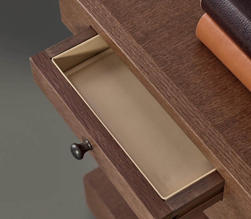 Leather drawer detail of Zoe, a wooden bedside table with wheels and a bronze knob from the Promemoria's catalogue | Promemoria