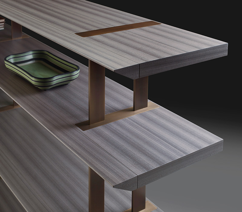 Detail of Cora, a wooden modular bookcase with bronze details, from Promemoria's Indigo Tales collection | Promemoria