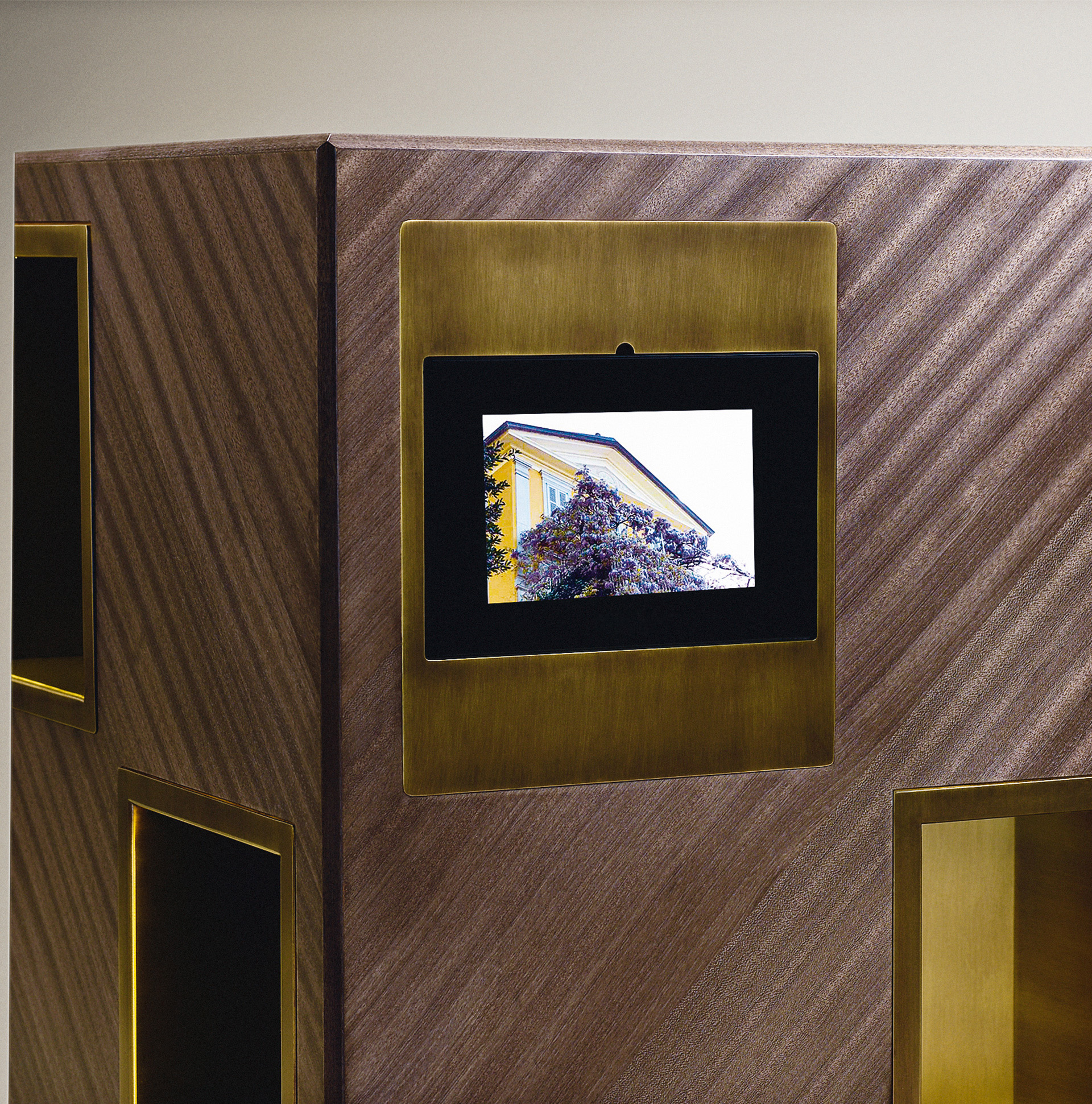 Detail of Meryl, a revolving wooden bookcase with bronze compartments from the Promemoria's catalogue | Promemoria