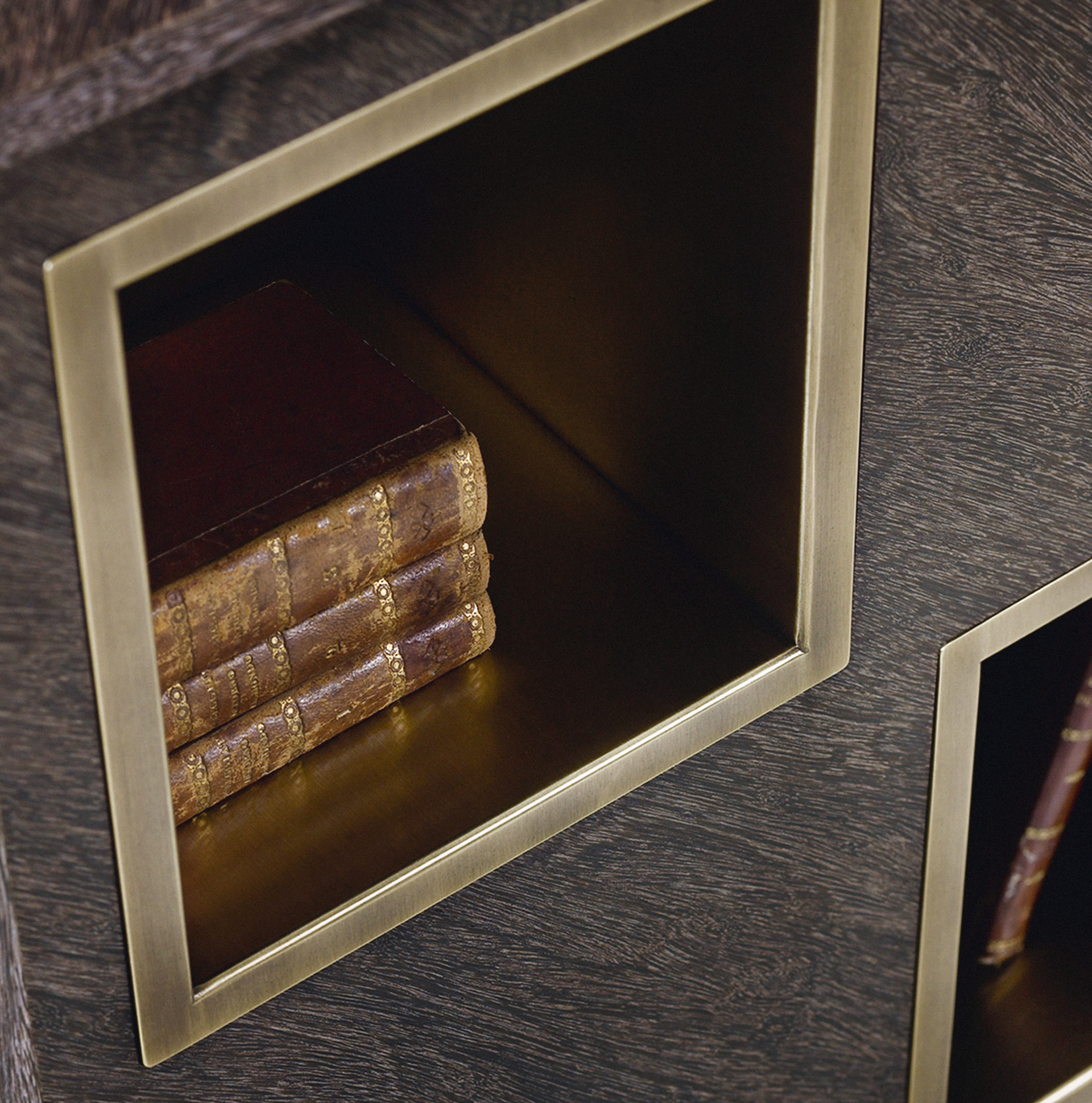 Detail of the bronze compartments of Meryl, a revolving wooden bookcase from the Promemoria's catalogue | Promemoria