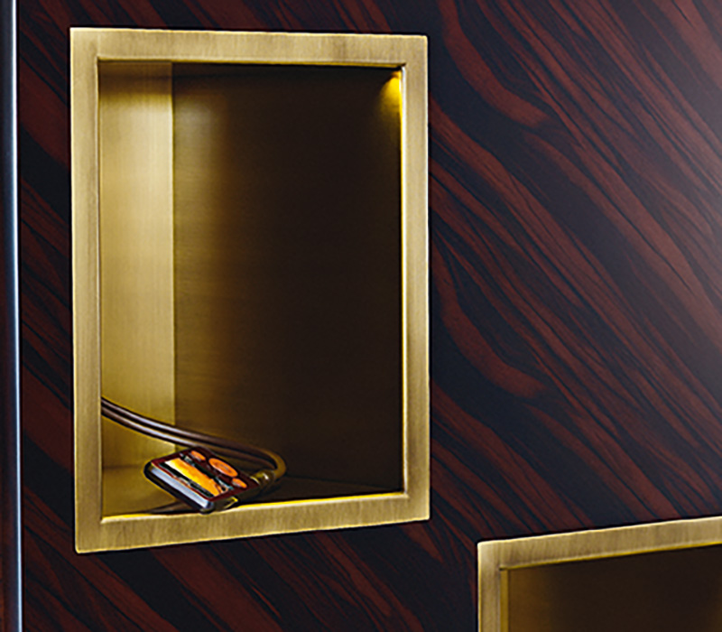 Detail of the bronze compartments of Meryl, a revolving wooden bookcase from the Promemoria's catalogue | Promemoria