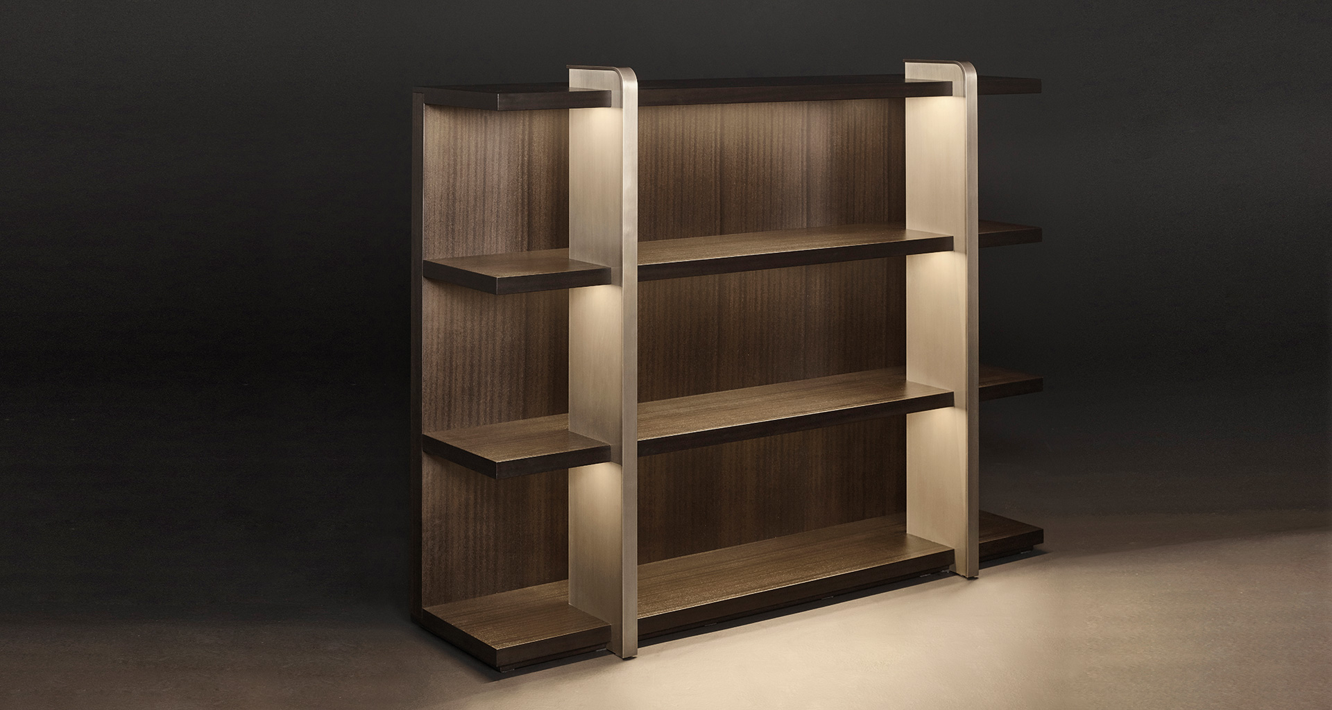 Nisha is a wooden bookcase with bronze supports from the Promemoria's Night Tales collection | Promemoria