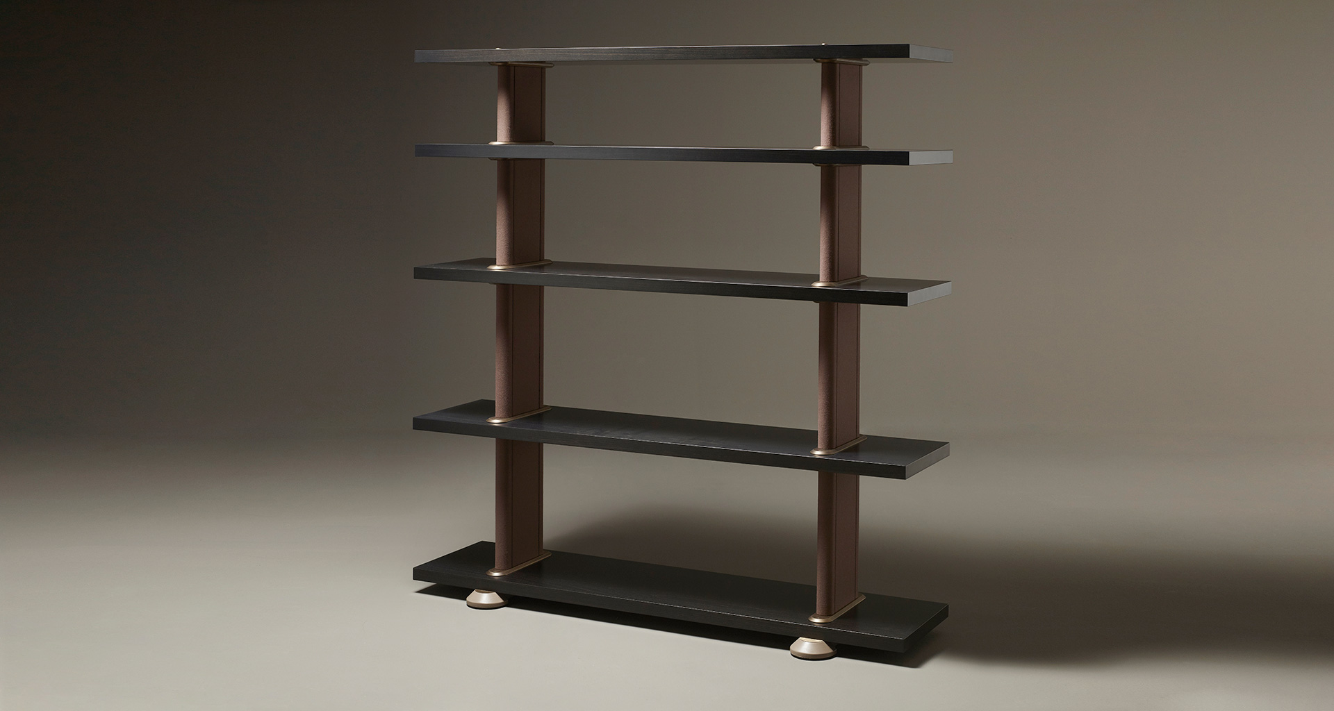 Peggy, a modular wooden bookcase with leather covered supports and bronze details, from Promemoria's catalogue | Promemoria