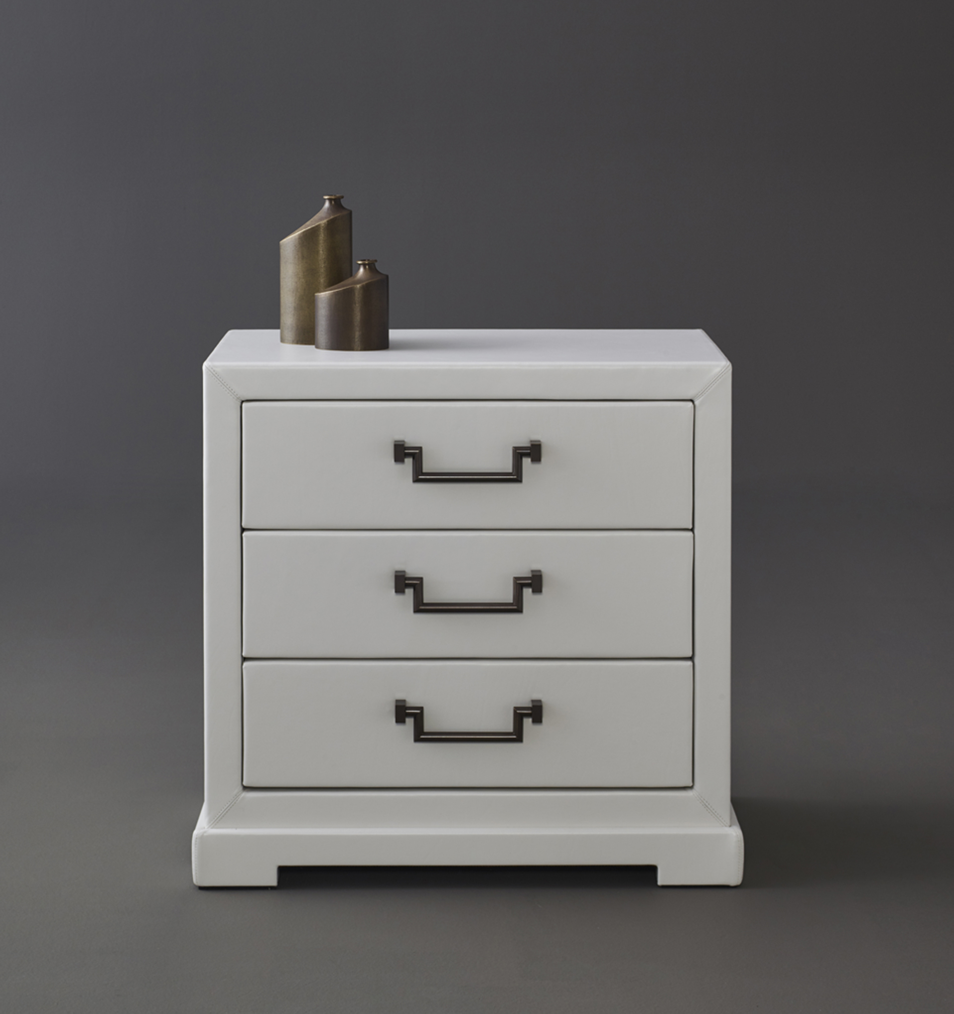 Drawer detail of Future, a wooden chest of drawers covered in leather or fabric with leather placemats and handles in leather or bronze, nickel and chrome from Promemoria's catalogue | Promemoria