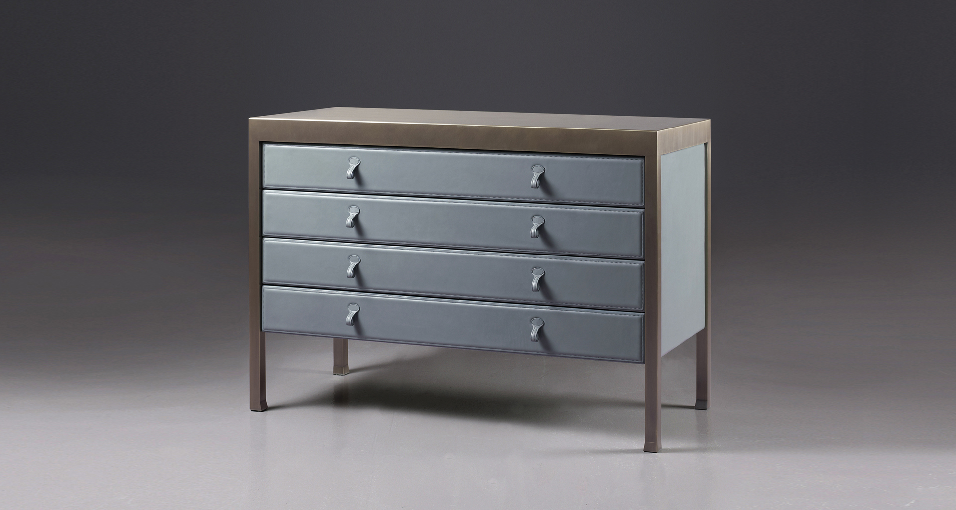 Gong is a bronze chest of drawers covered in fabric or leather from Promemoria's catalogue | Promemoria