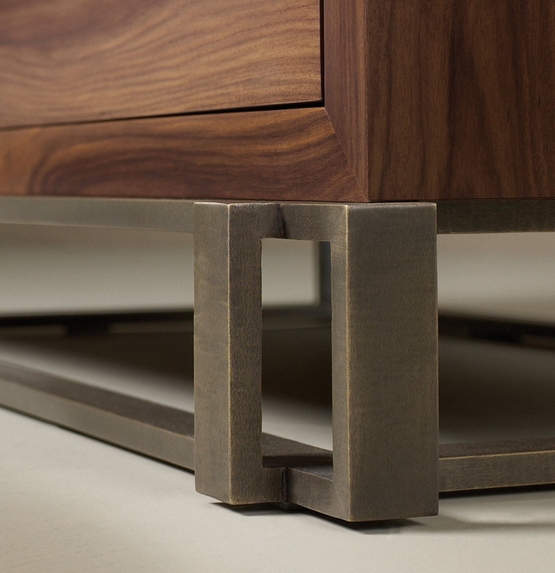 Margot is a wooden chest of drawers with metal details and bronze base and knobs from Promemoria's catalogue | Promemoria