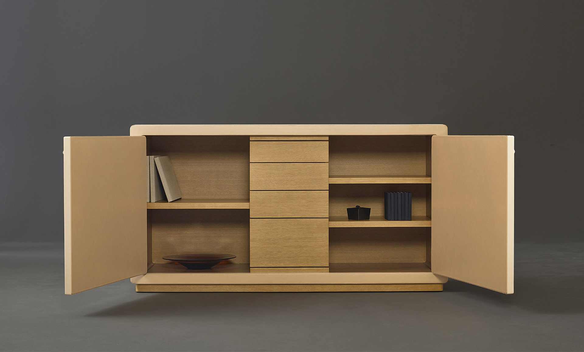 Inside of Future Voyager Atto II, a wooden cabinet covered in leather and fabric with handles and placemats in leather from Promemoria's catalogue | Promemoria