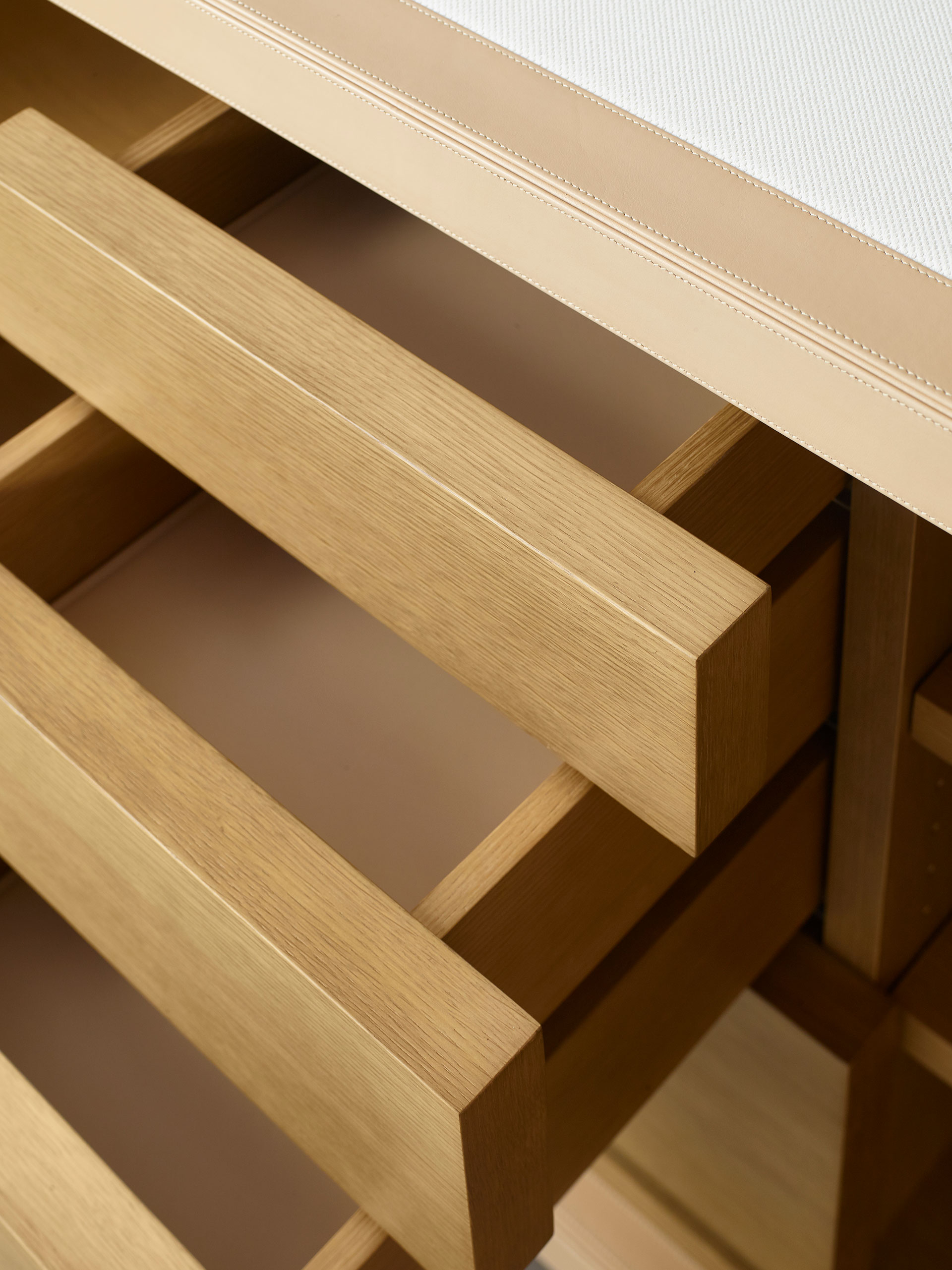 Drawers' detail of Future Voyager Atto II, a wooden cabinet covered in leather and fabric with handles and placemats in leather from Promemoria's catalogue | Promemoria