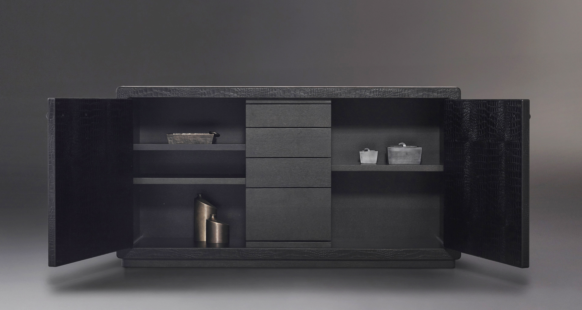 Inside of Future Voyager Atto II, a wooden cabinet covered in leather and fabric with handles and placemats in leather from Promemoria's catalogue | Promemoria