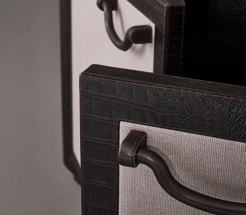 Leather handle detail of Future Voyager Atto II, a wooden cabinet covered in leather and fabric with handles and placemats in leather from Promemoria's catalogue | Promemoria