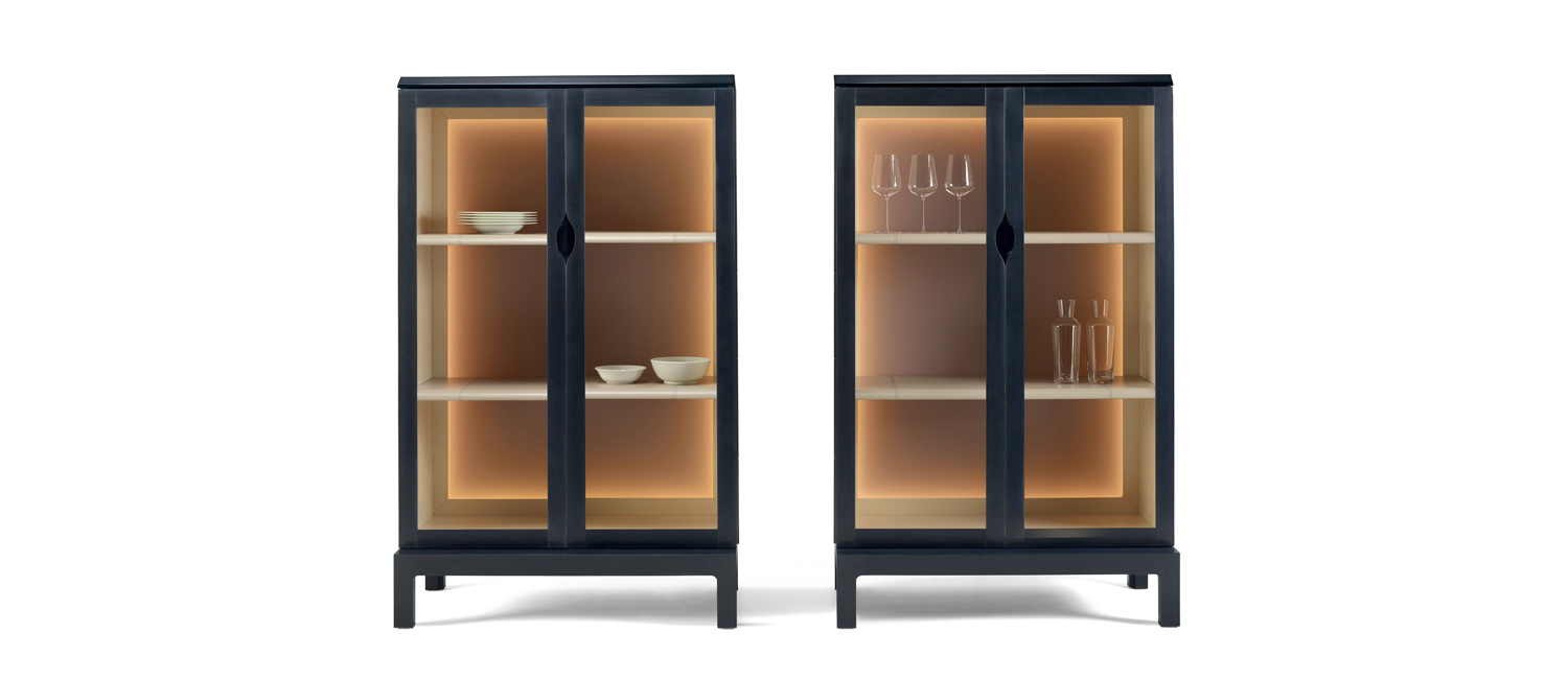 /mediaLaos%20is%20a%20wooden%20cabinet%20with%20a%20recessed%20handle%20and%20wooden%20or%20glass%20doors%20from%20Promemoria's%20Indigo%20Tales%20collection%20|%20Promemoria
