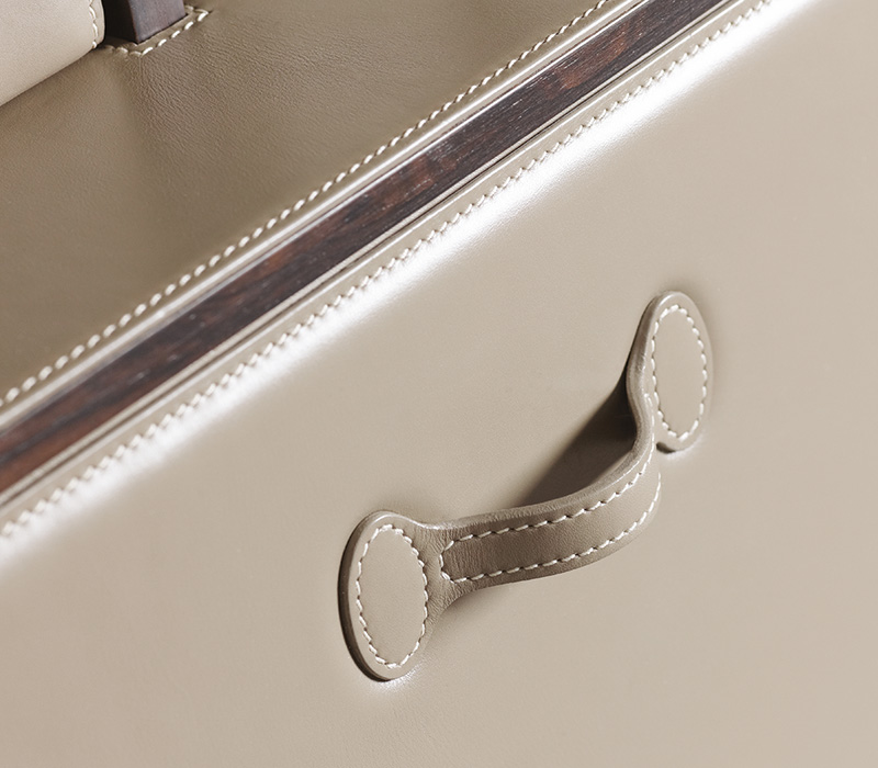 Inside detail of Stanley, a wooden cabinet with a bronze handle and internal modules covered in leather from Promemoria's catalogue | Promemoria