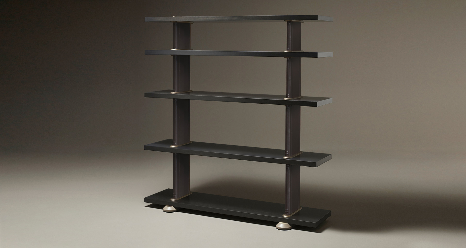 Peggy, a modular wooden bookcase with leather covered supports and bronze details, from Promemoria's catalogue | Promemoria
