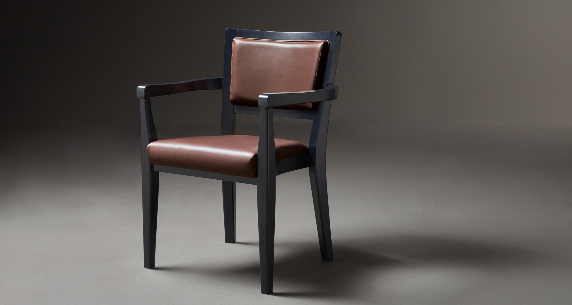 Bistrot è una sedia da pranzo in legno con braccioli e seduta e schienale in tessuto o pelle, del catalogo di Promemoria | Promemoria
