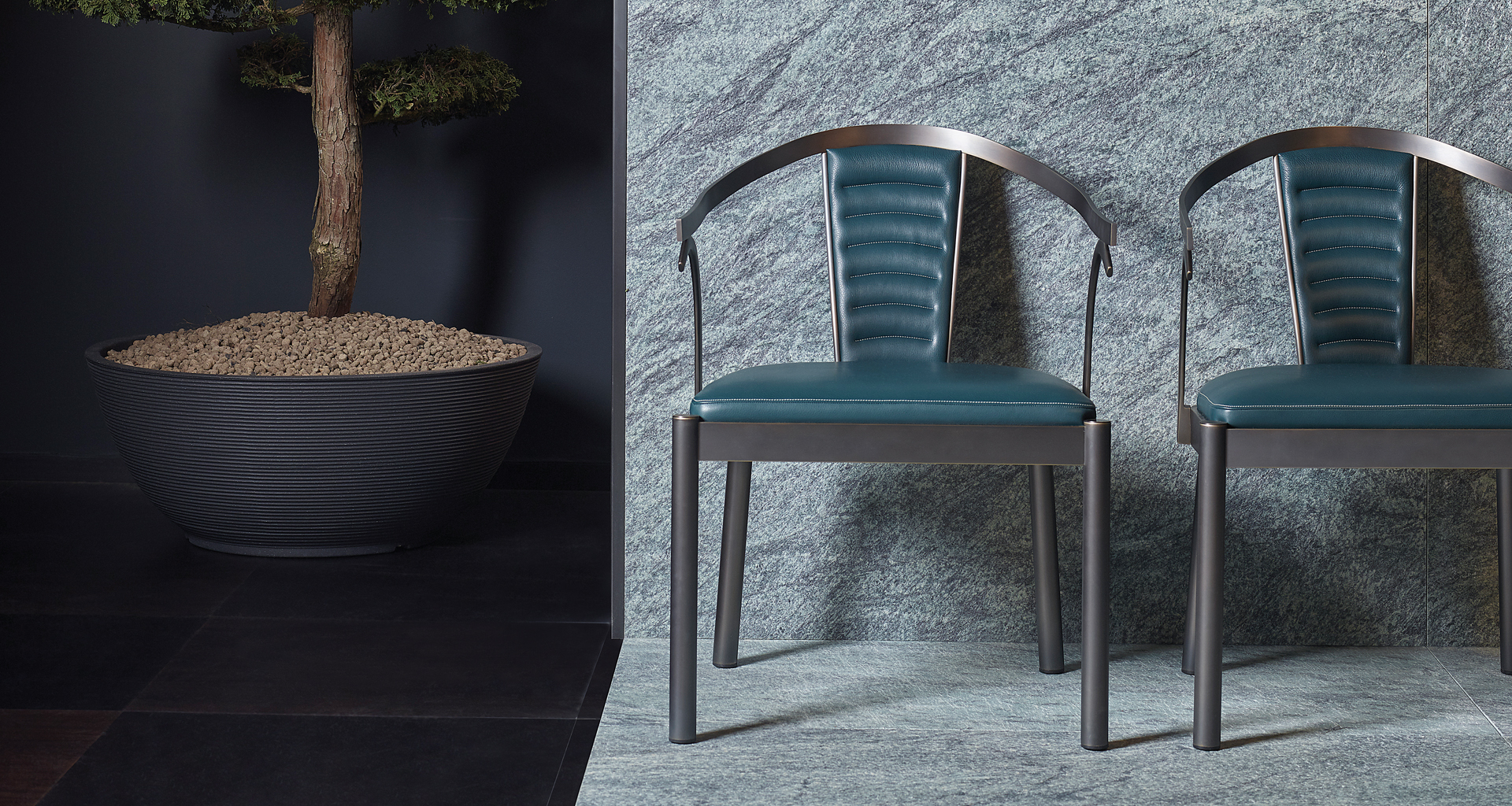 Detail of Jasmine, a bronze dining chair with armrests covered in leather, from Promemoria's catalogue | Promemoria