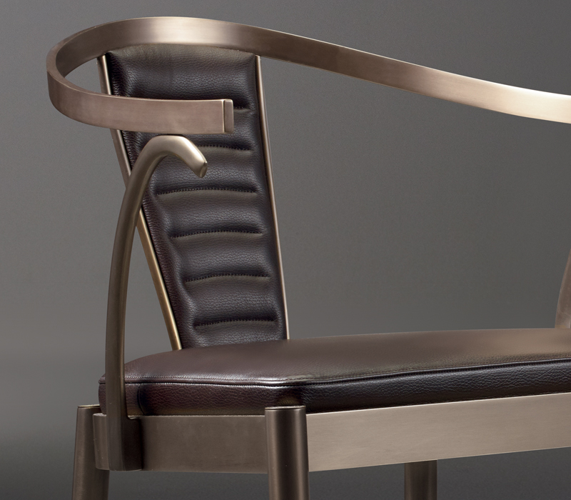 Detail of Jasmine, a bronze dining chair with armrests covered in leather, from Promemoria's catalogue | Promemoria