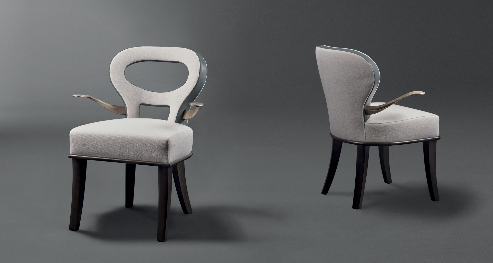 Moka e Roka are two wooden chairs covered in fabric and leather, with or without bronze armrests, from Promemoria's catalogue | Promemoria