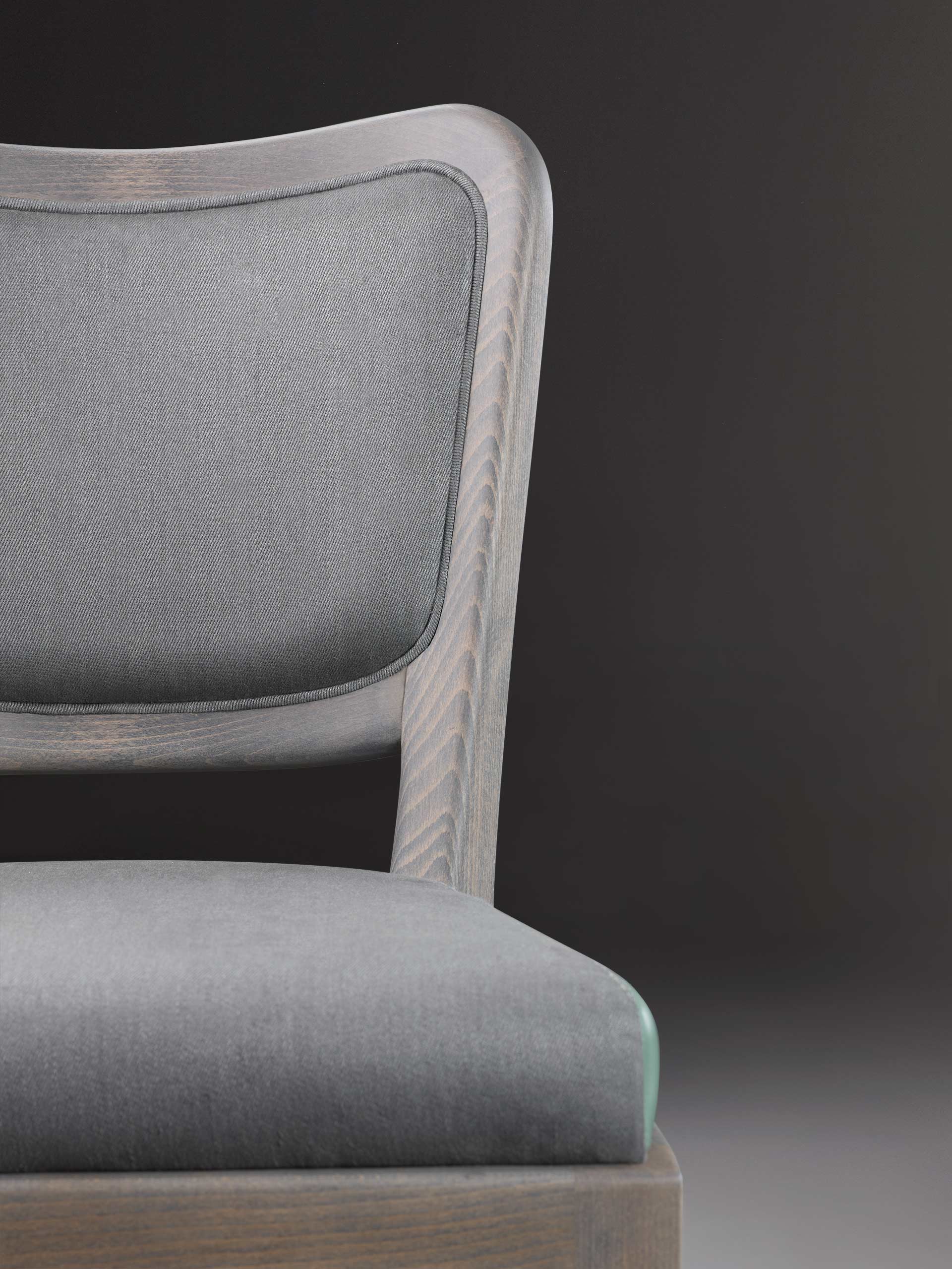 Detail of Pepita, a wooden dining chair with fabric or leather seat, from Promemoria's catalogue | Promemoria