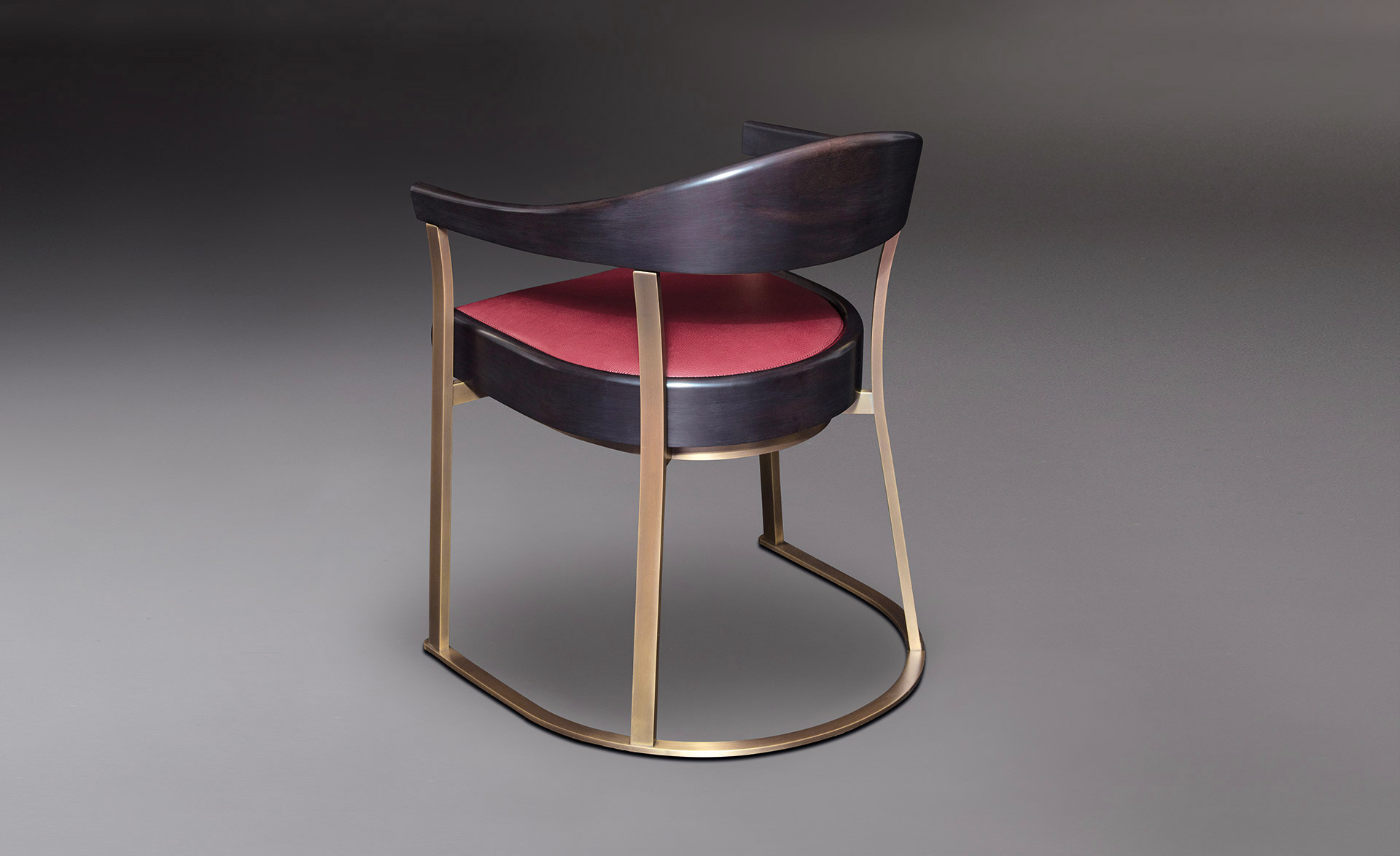 Rachele is a bronze chair with arms with wooden or leather back and leather seat, from Promemoria's catalogue | Promemoria