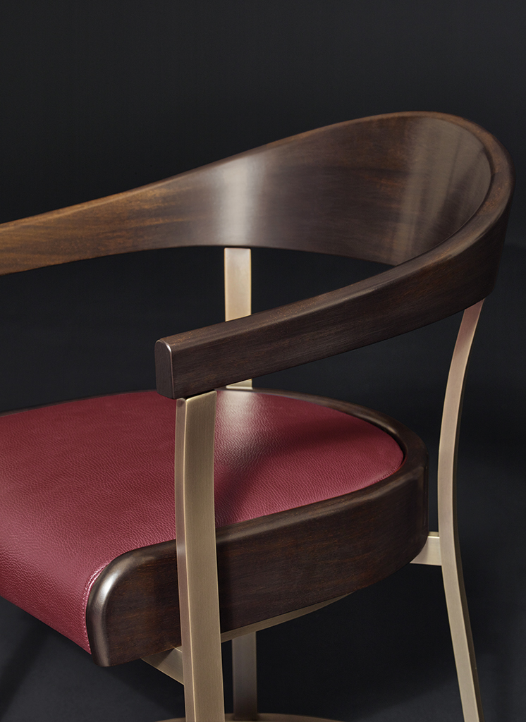 Rachele is a bronze chair with arms with wooden or leather back and leather seat, from Promemoria's catalogue | Promemoria
