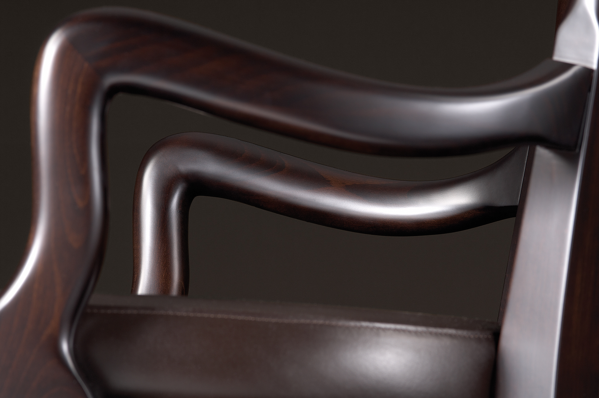 Detail of Sofia, a wooden dining chair with fabric or leather seat and with armrests, from Promemoria's catalogue | Promemoria
