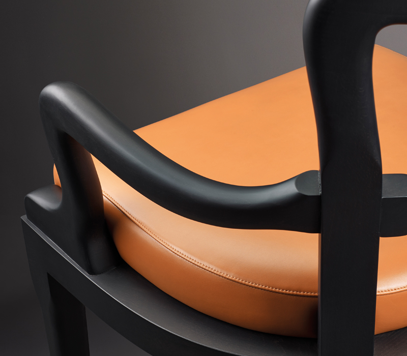 Detail of Sofia, a wooden dining chair with fabric or leather seat and with armrests, from Promemoria's catalogue | Promemoria