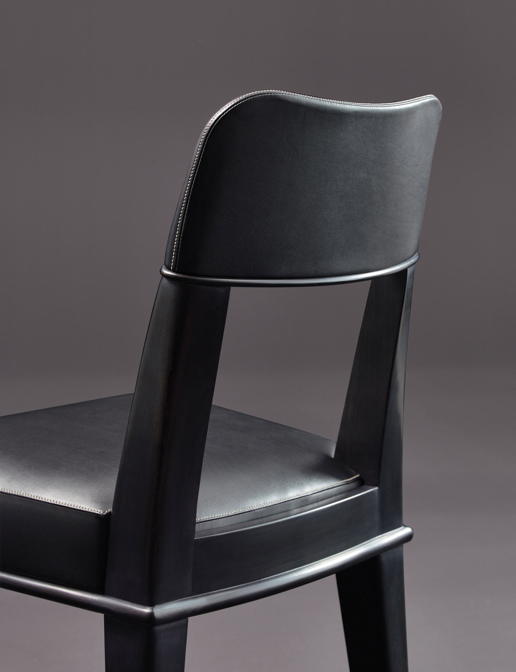 Detail of Vespertine, a wooden dining chair with leather seat and back, from Promemoria's Night Tales collection | Promemoria