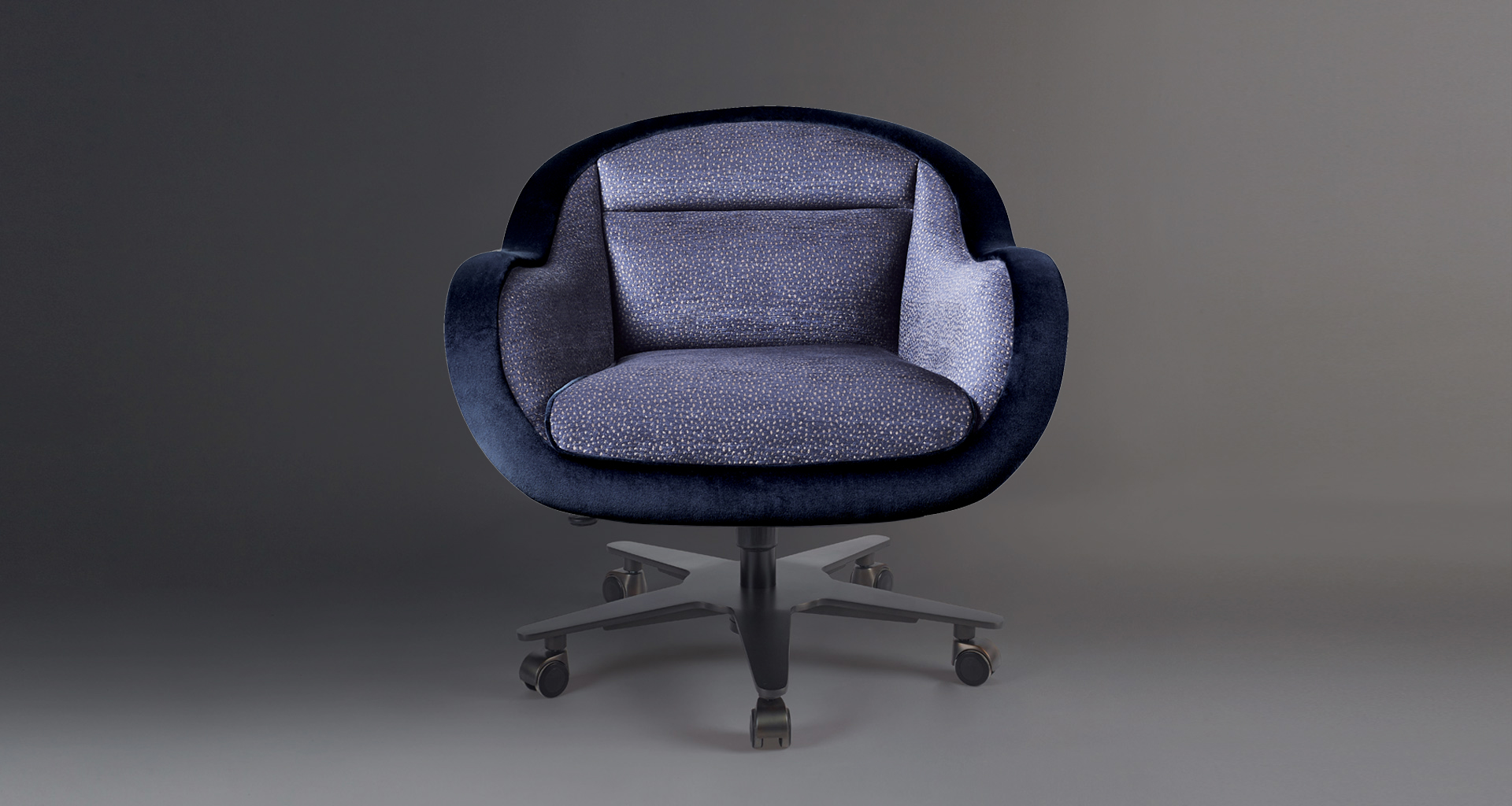 Vittoria is an office chair with a metal or bronze base, covered in fabric or leather with a bronze handle on the back, from Promemoria's catalogue | Promemoria