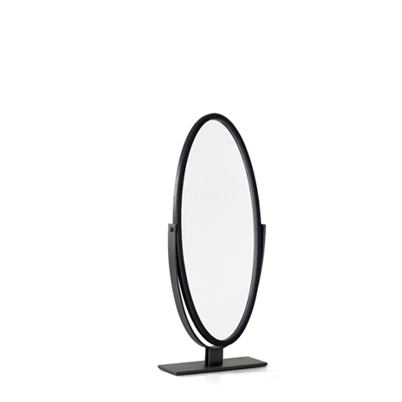 Ingrid is an elliptical revolving mirror with a bronzed metal base, from the Promemoria's catalogue | Promemoria