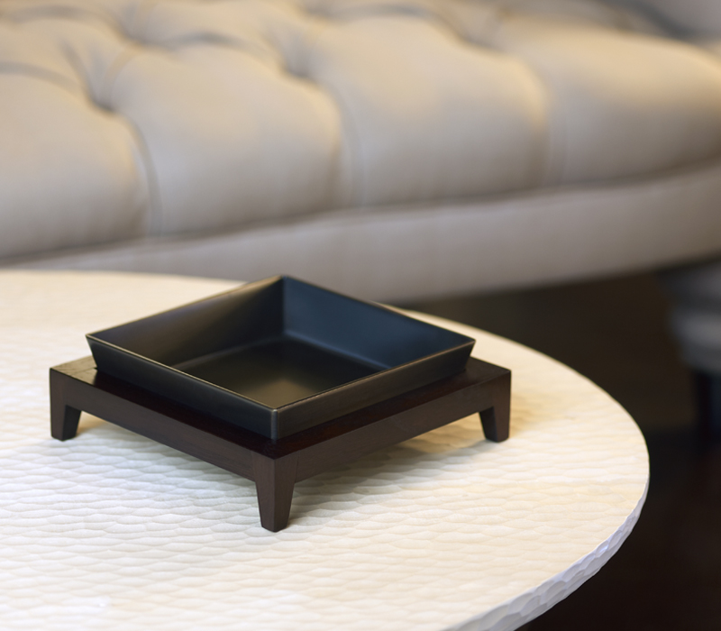 Detail of Santos, a wooden tray with a bronze base, from Promemoria's catalogue | Promemoria