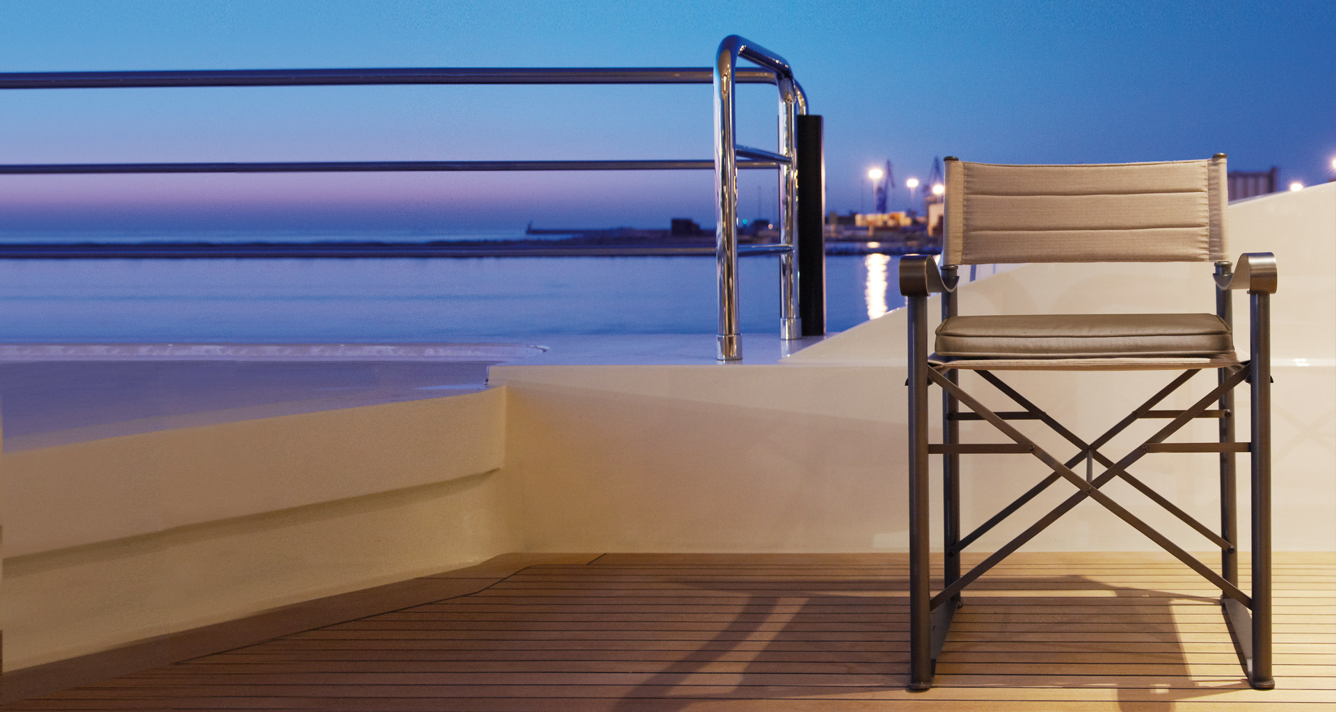 Quentin is a veranda folding chair and bench in bronze and covered in fabric, from Promemoria's outdoor catalogue | Promemoria