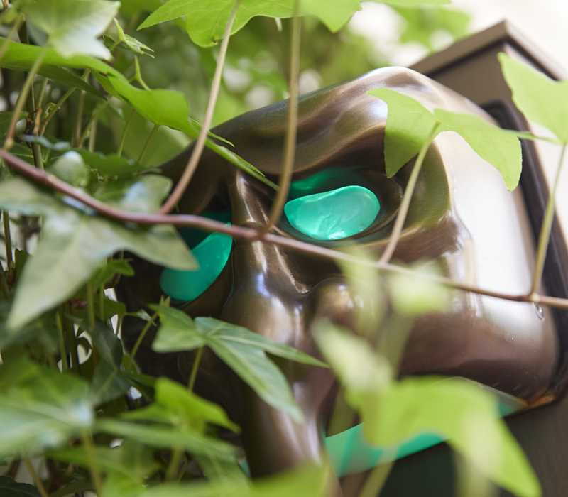 Detail of Maschera, a family of outdoor bronze wall lamps, from Promemoria's outdoor catalogue | Promemoria