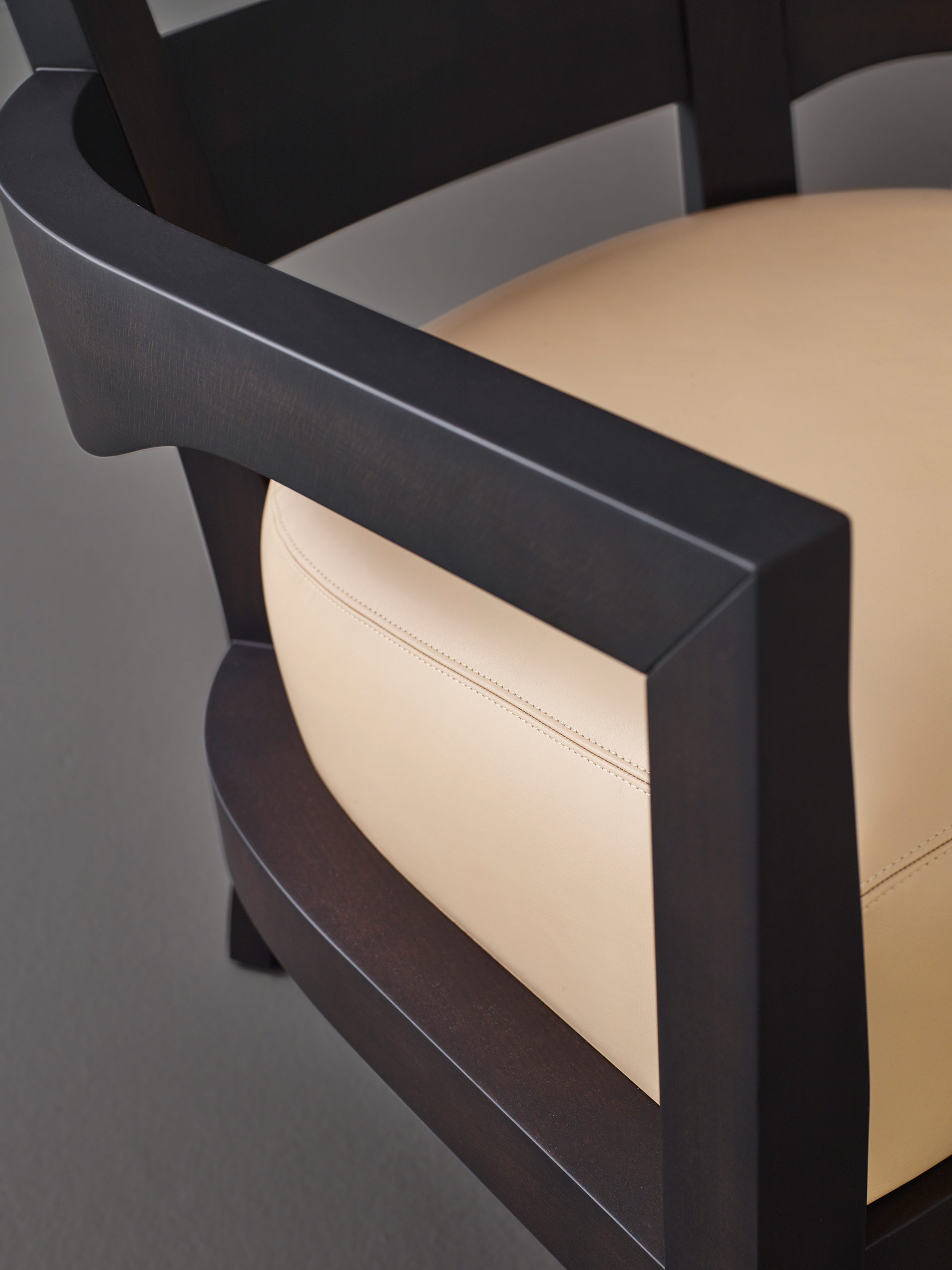 Armrest detail of Africa, a wooden armchair covered in fabric or leather, from Promemoria's catalogue | Promemoria