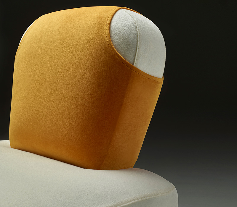 Detail of Bomb, an armchair covered in velvets in different colors with a gillet on the back, from Promemoria's Indigo Tales collection | Promemoria