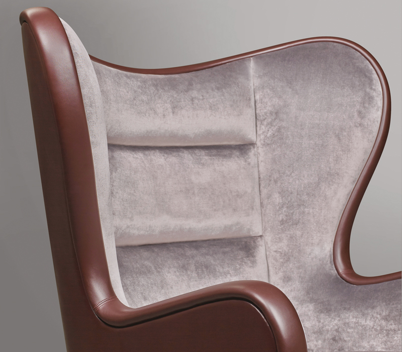 Butterfly is an armchair covered in fabric and leather with a revolving bronze base, from Promemoria's catalogue | Promemoria