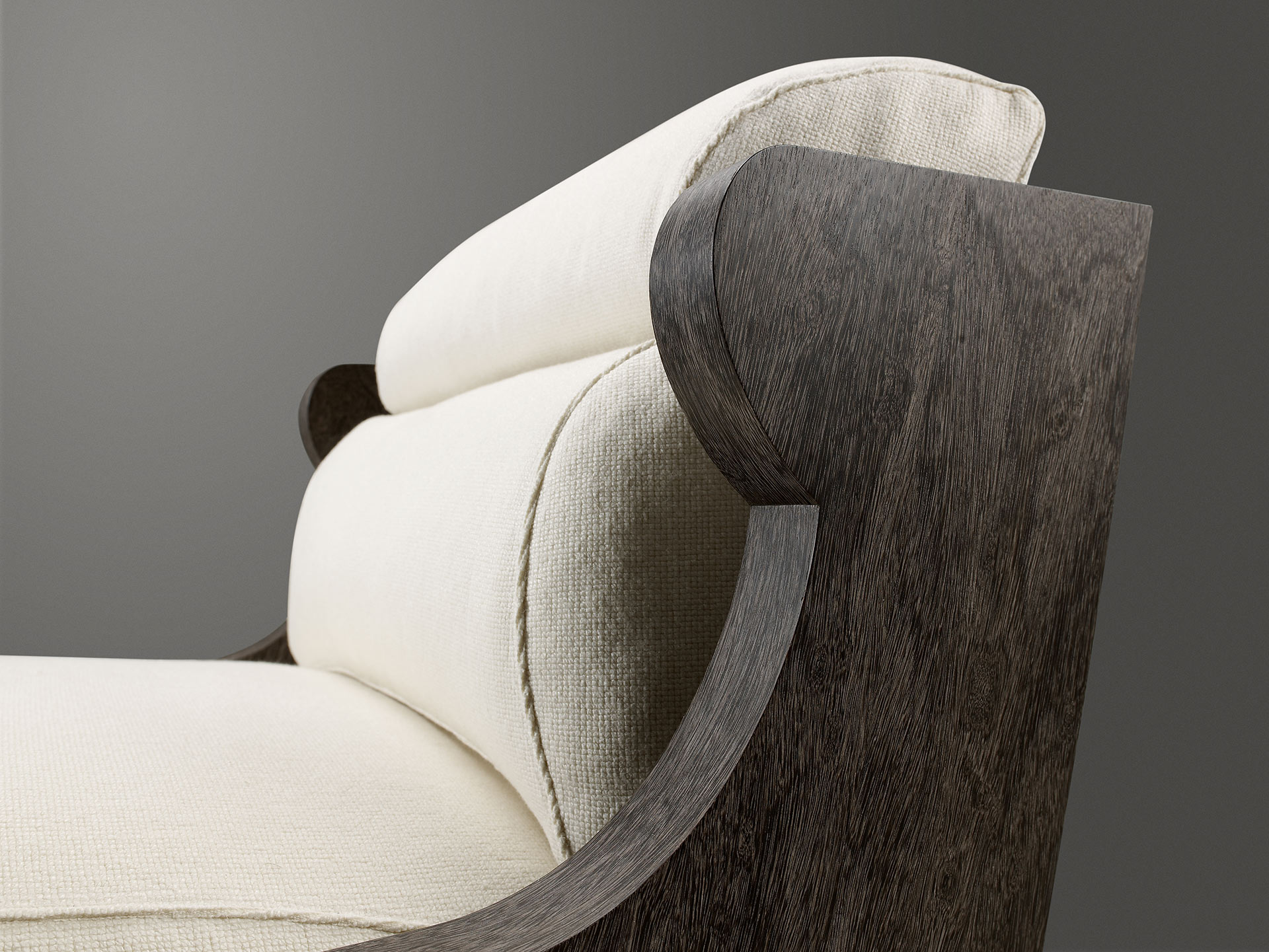 Detail of Gilda, a wooden armchair covered in fabric with bronze feet, from Promemoria's catalogue | Promemoria