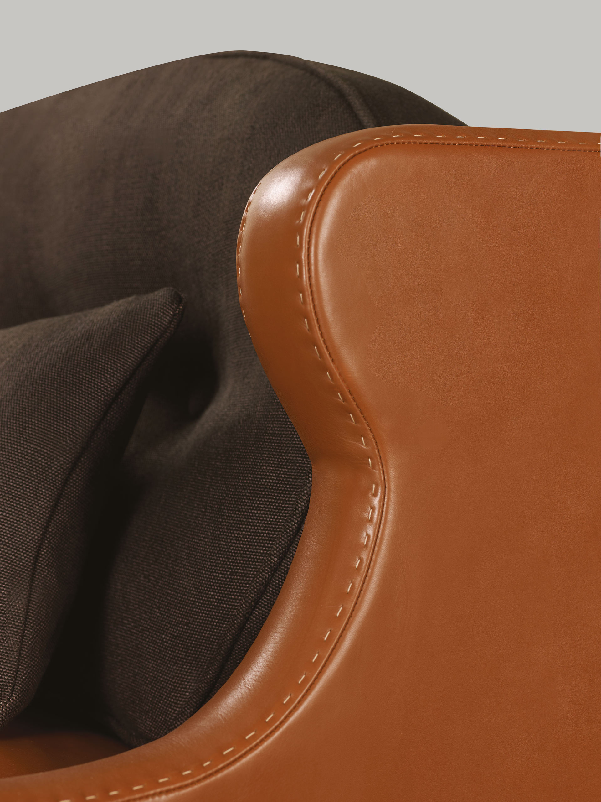 Detail of Gilda, a wooden armchair covered in fabric with bronze feet, from Promemoria's catalogue | Promemoria