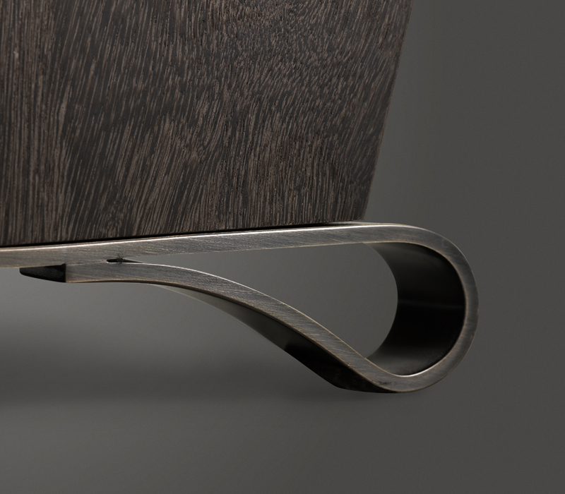 Bronze feet detail of Gilda, a wooden armchair covered in fabric, from Promemoria's catalogue | Promemoria