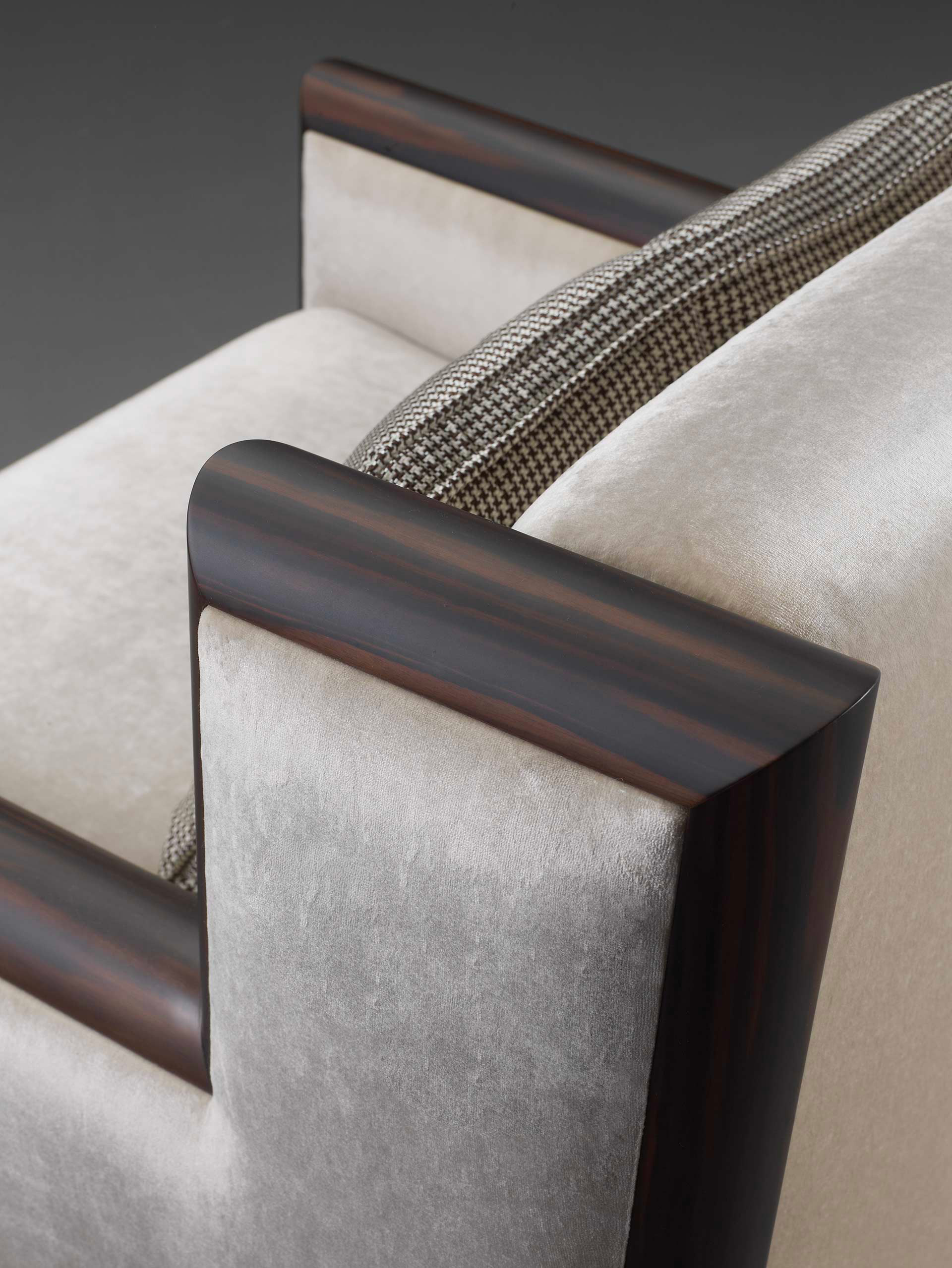 Detail of Ginevra, a wooden armchair covered in leather or fabric with bronze feet, from Promemoria's catalogue | Promemoria