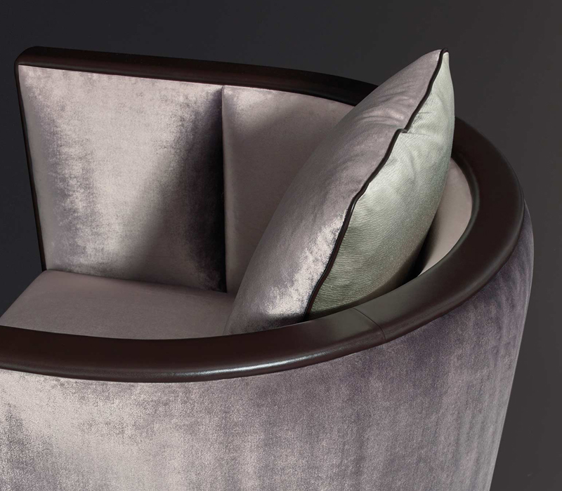 Detail of Grosvenor, a wooden armchair with fabric covering and leather details, from Promemoria's The London Collection | Promemoria