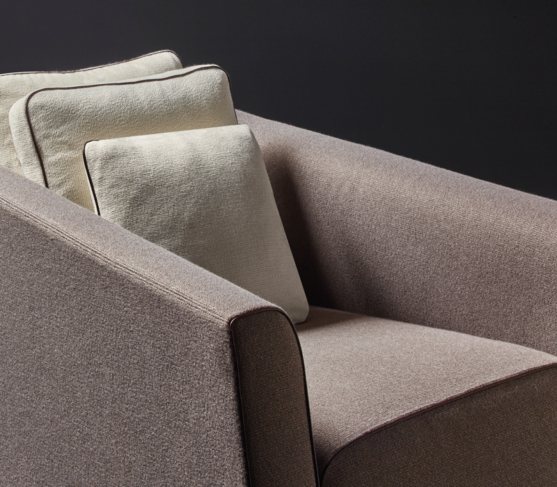 Detail of Martini, an armchair covered in fabric or leather with bronze feet, from Promemoria's catalogue | Promemoria