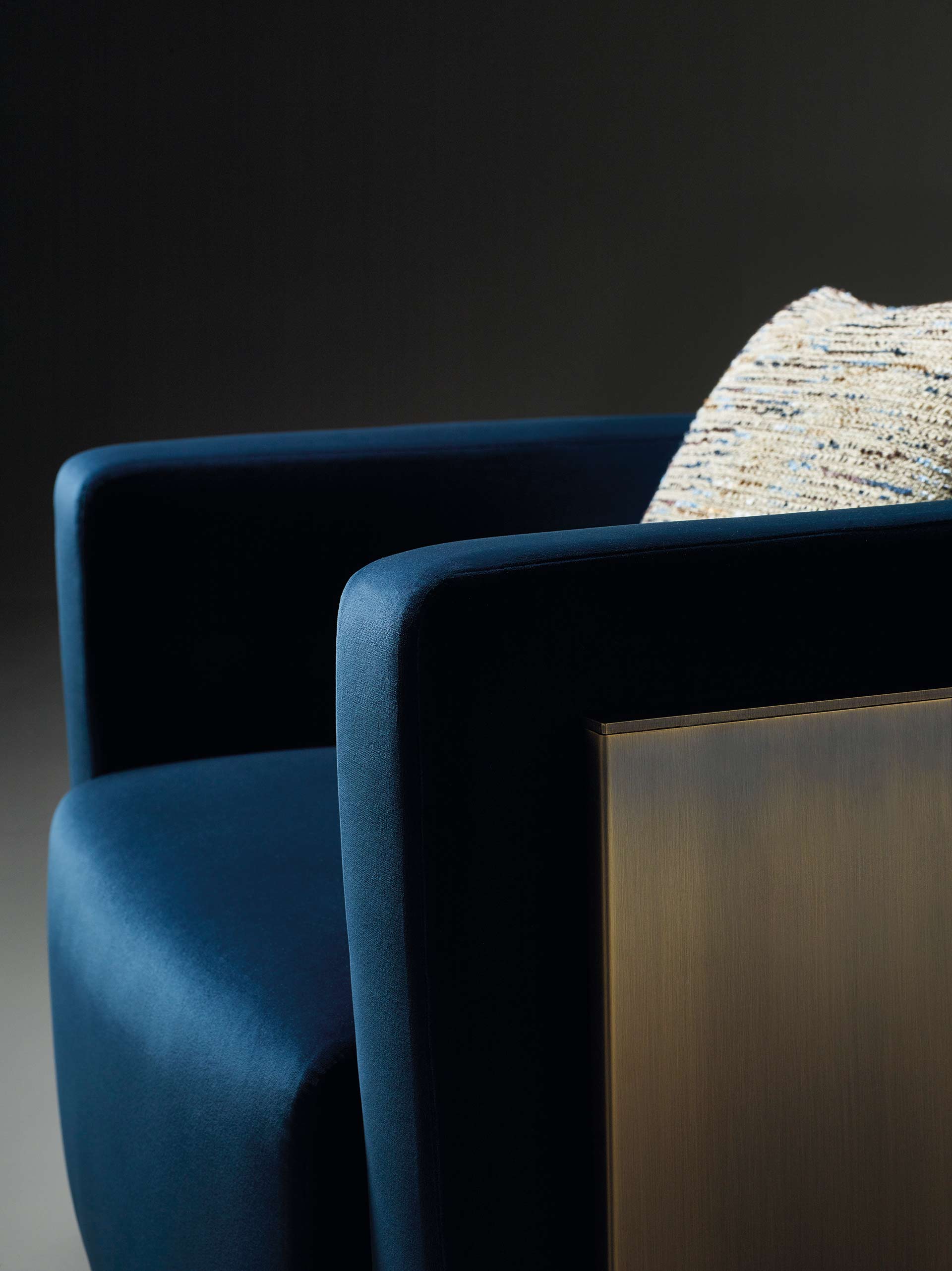 Detail of Pervinca, a swivel bronze armchair with a wooden base and fabric covering, from Promemoria's Amaranthine Tales collection | Promemoria
