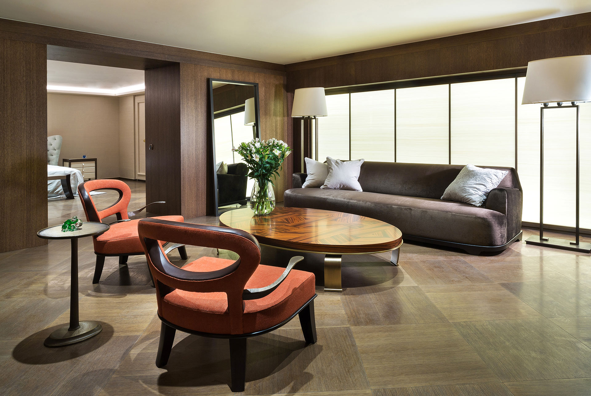 Roka Large is a large wooden armchair covered in fabric and leather with bronze arms, from Promemoria's catalogue | Promemoria