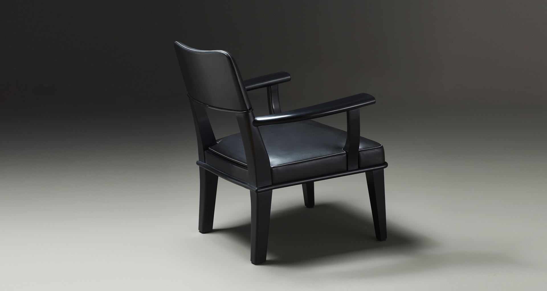 Vespertine is a wooden lounge armchair with leather seat and back, from Prommeoria's catalogue | Promemoria