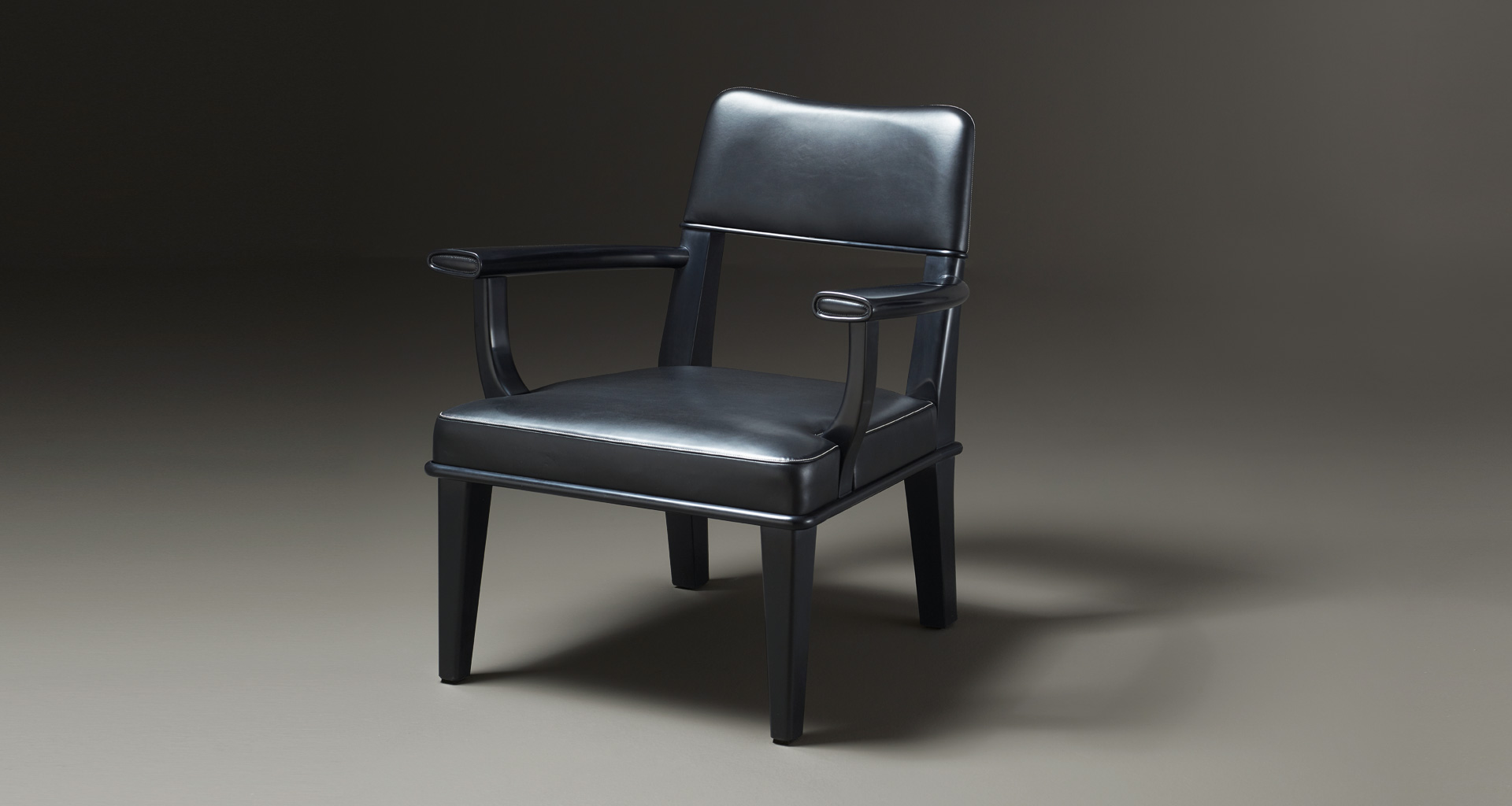 Vespertine is a wooden lounge armchair with leather seat and back, from Prommeoria's catalogue | Promemoria