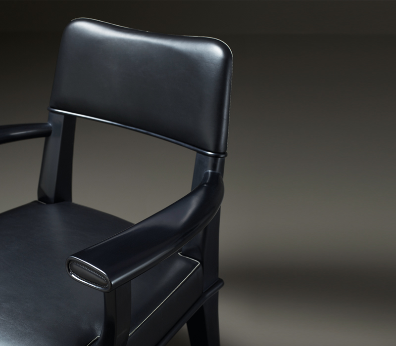 Detail of Vespertine, a wooden lounge armchair with leather seat and back, from Prommeoria's catalogue | Promemoria