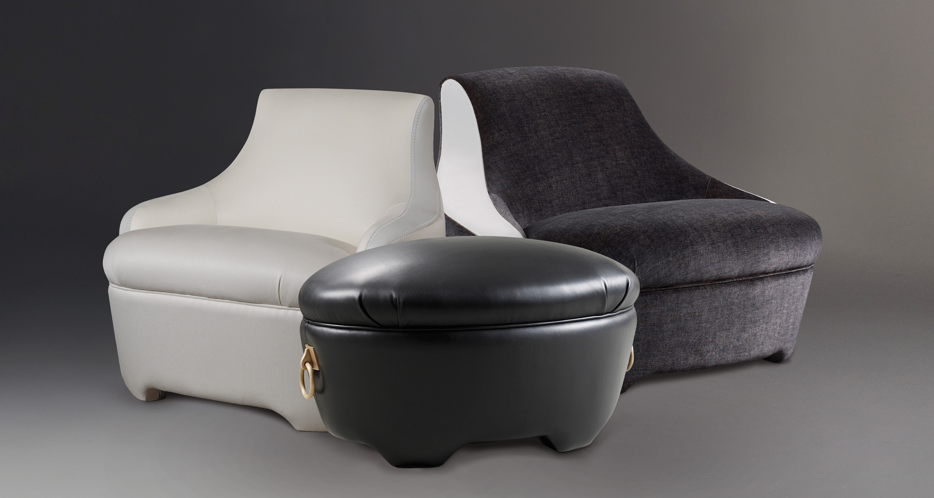 Gioconda is a pouf covered in fabric or leather with bronze handles, from Promemoria's catalogue | Promemoria